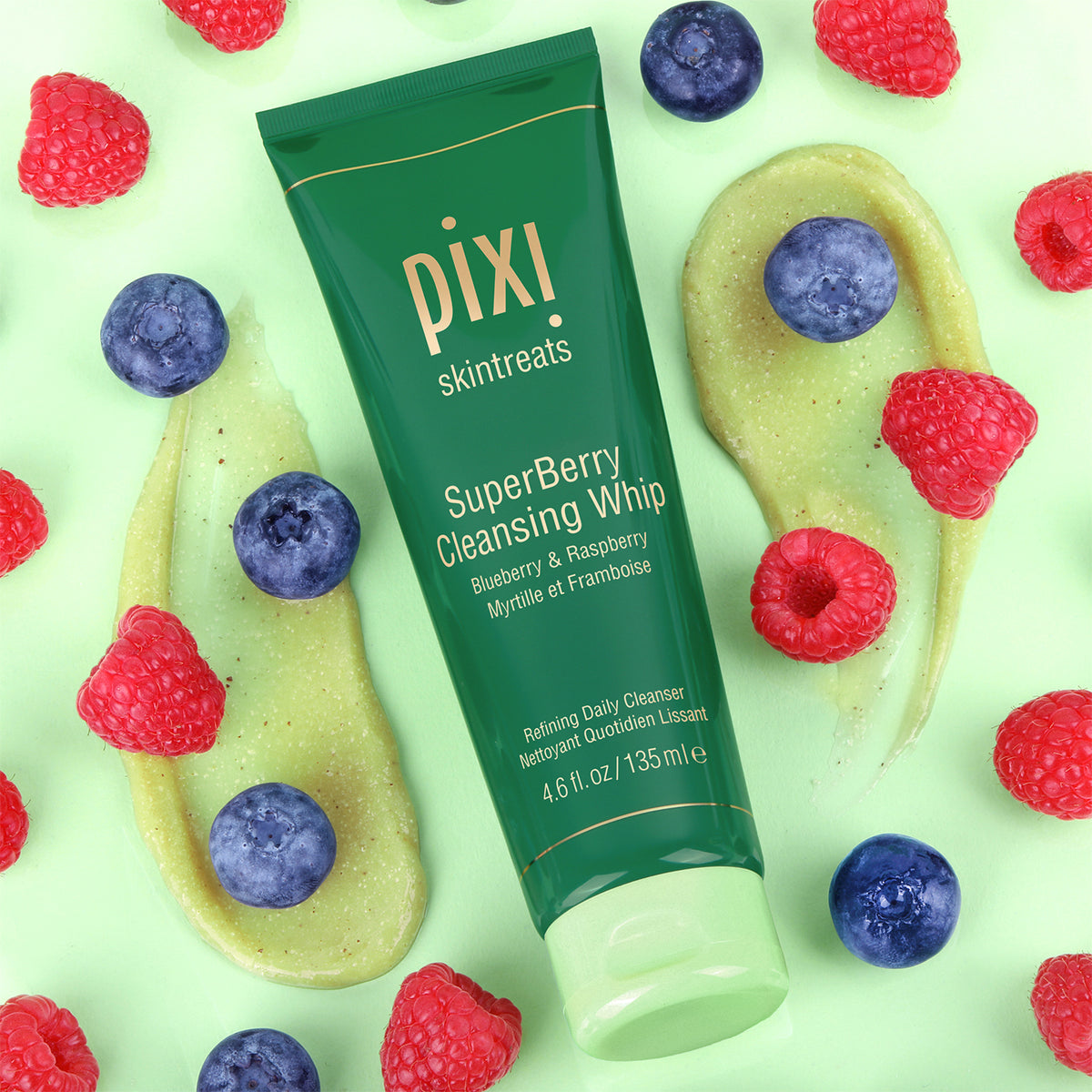 Pixi SuperBerry Cleansing Whip tube surrounded by berries on a green background